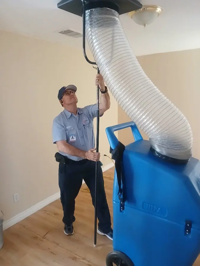 Furnace Tune-Up technician using HEPA equipment in Danville